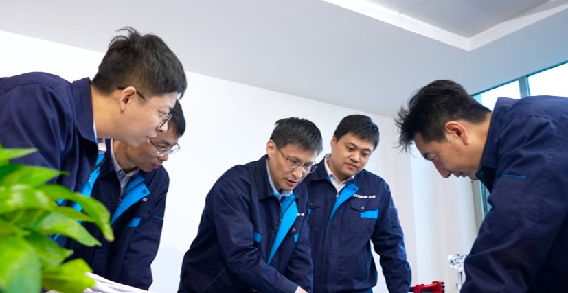 Surface-treatment engineers reviewing a part
